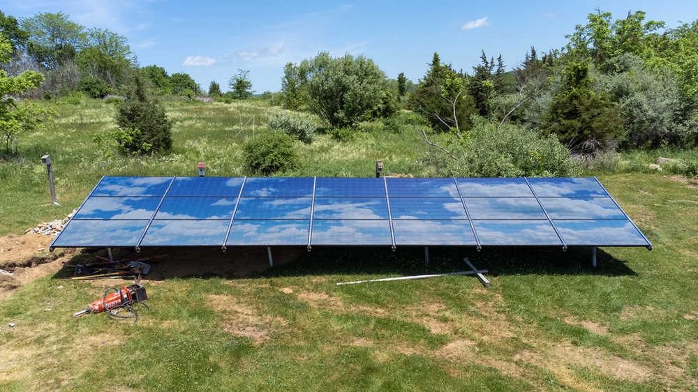 Ground mount design displays the sky and cumulus clouds to enhance the aesthetics of the solar panels