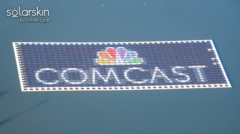 Comcast logo powered by SolarSkin on floating solar array